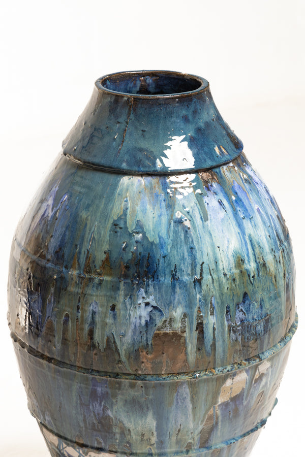 Discover a vessel adorned with enchanting glazes in shades of blue, bronze, and earthy green—a testament to the intricate fusion of colour - FCKFMG