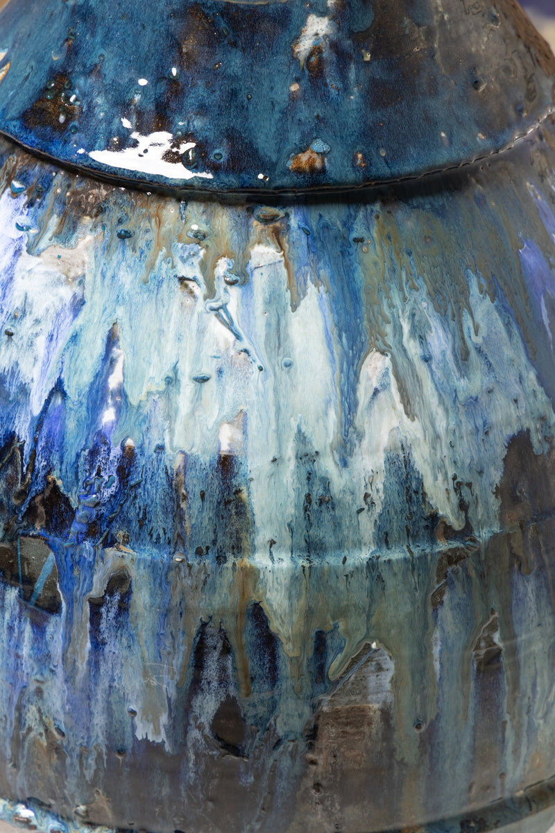 Discover a vessel adorned with enchanting glazes in shades of blue, bronze, and earthy green—a testament to the intricate fusion of colour - FCKFMG